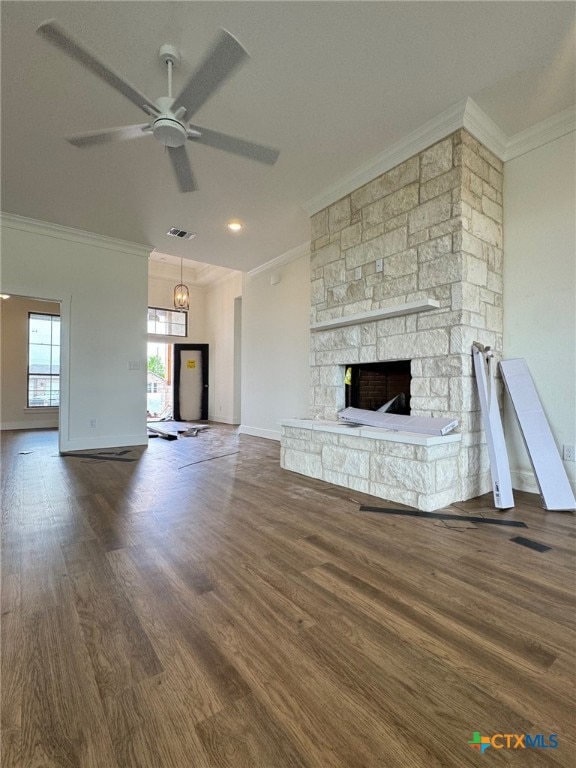 10826 Campsite Cv, Temple, TX 76502 - unfurnished living room with wood finished floors, crown molding, baseboards, a stone fireplace, and ceiling fan