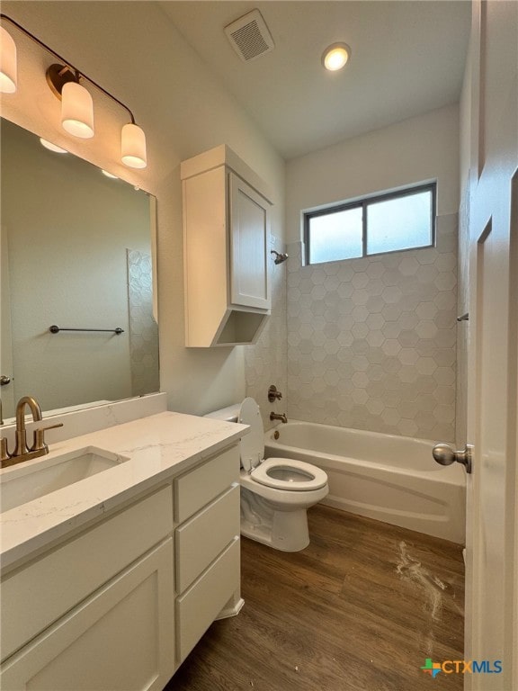 10826 Campsite Cv, Temple, TX 76502 - bathroom with toilet, visible vents, vanity, wood finished floors, and shower / bathing tub combination
