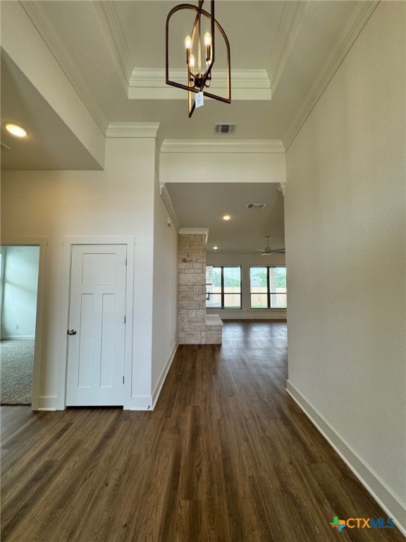 10826 Campsite Cv, Temple, TX 76502 - hall with dark wood-style flooring, a chandelier, baseboards, a raised ceiling, and ornamental molding
