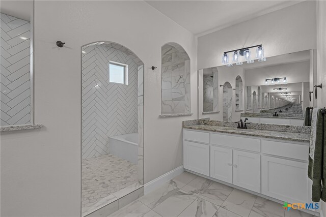 bathroom featuring vanity and plus walk in shower