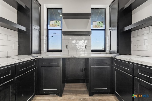 kitchen featuring light stone countertops and tasteful backsplash