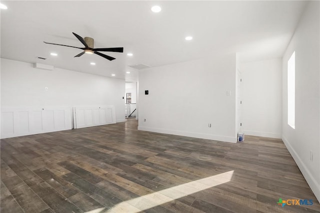 spare room featuring ceiling fan and dark hardwood / wood-style flooring