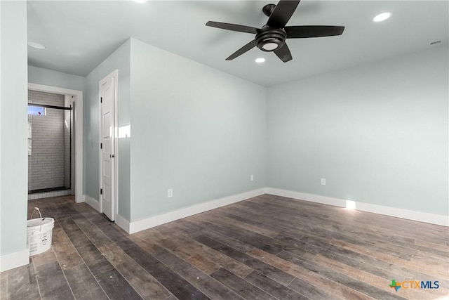 unfurnished room featuring ceiling fan and dark hardwood / wood-style flooring