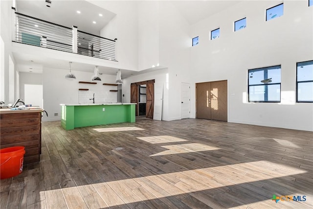 living room featuring a high ceiling and sink