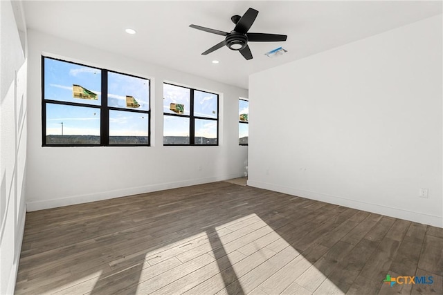 unfurnished room with ceiling fan and wood-type flooring