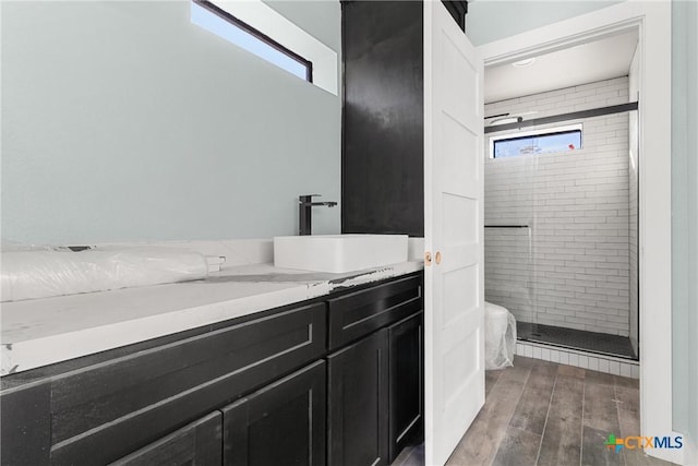 bathroom featuring an enclosed shower and vanity