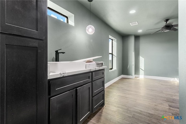 bathroom featuring ceiling fan and wood-type flooring