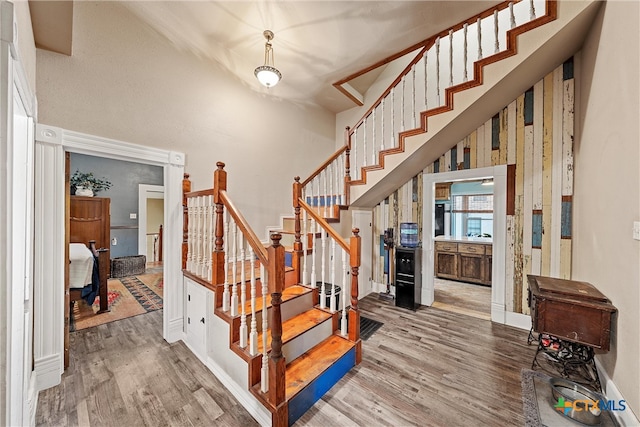 stairs with hardwood / wood-style flooring