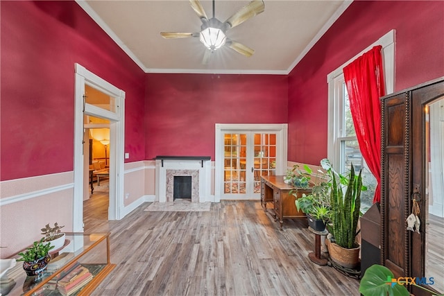 unfurnished room featuring hardwood / wood-style flooring, ceiling fan, crown molding, and french doors