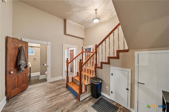 entryway with hardwood / wood-style flooring and vaulted ceiling