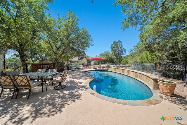 view of swimming pool with a fenced backyard, a patio, and outdoor dining area