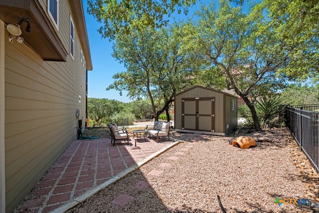 fenced backyard featuring a patio, a storage shed, and an outdoor structure