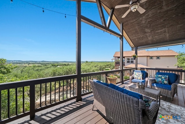 deck with an outdoor living space and a ceiling fan