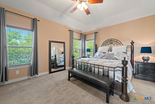 carpeted bedroom with multiple windows, baseboards, and ceiling fan
