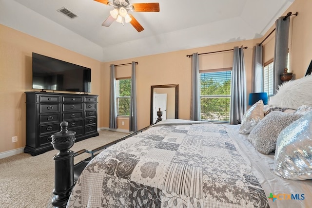 bedroom featuring multiple windows, carpet, baseboards, lofted ceiling, and a ceiling fan