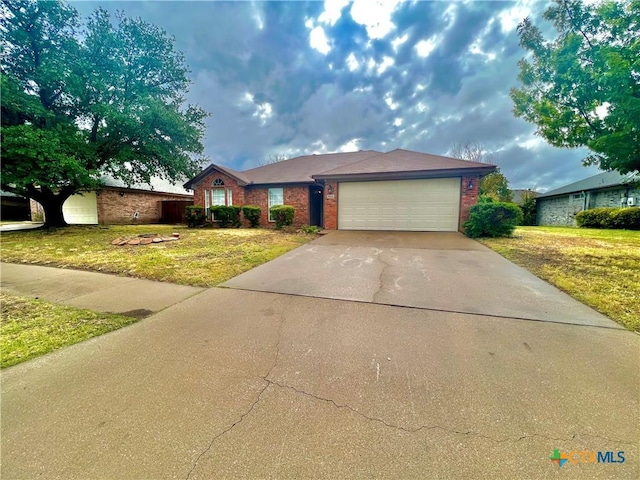 single story home featuring a garage and a front lawn