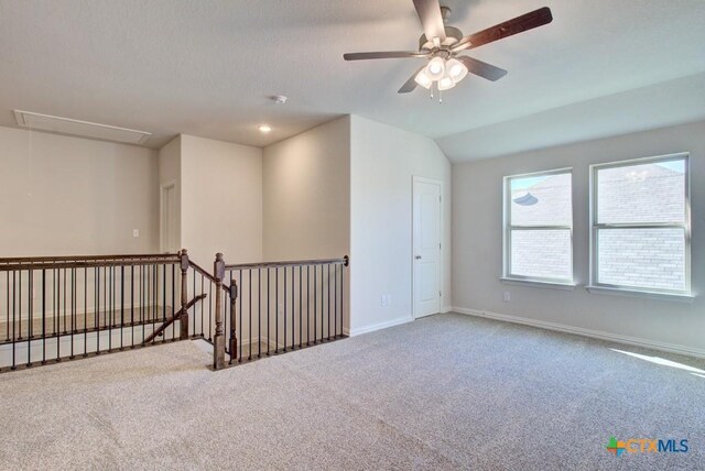 carpeted empty room with ceiling fan and lofted ceiling