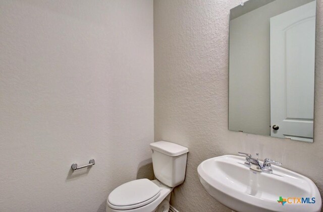 bathroom with toilet and sink