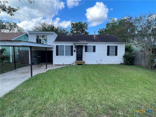 view of front of home with a carport and a front lawn