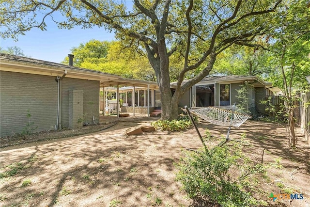 3426 Austin Ave, Waco, TX 76710 - rear view of house featuring brick siding and a sunroom