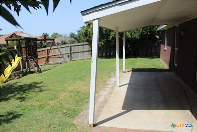 view of yard with a playground and a patio