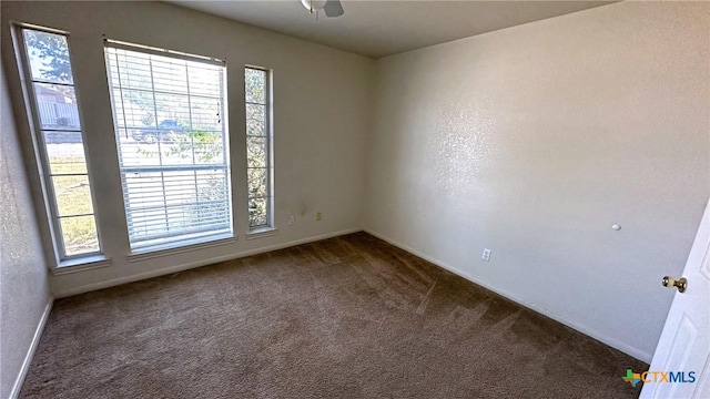 1302 Creek St, Copperas Cove, TX 76522 - spare room with dark colored carpet, baseboards, and ceiling fan