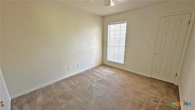 spare room with light carpet and ceiling fan