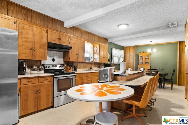 210 N 8th St, Lometa, TX 76853 - kitchen featuring appliances with stainless steel finishes, under cabinet range hood, light countertops, light flooring, and a textured ceiling