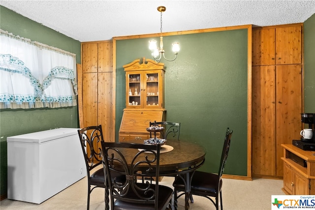 dining room featuring an inviting chandelier and a textured ceiling