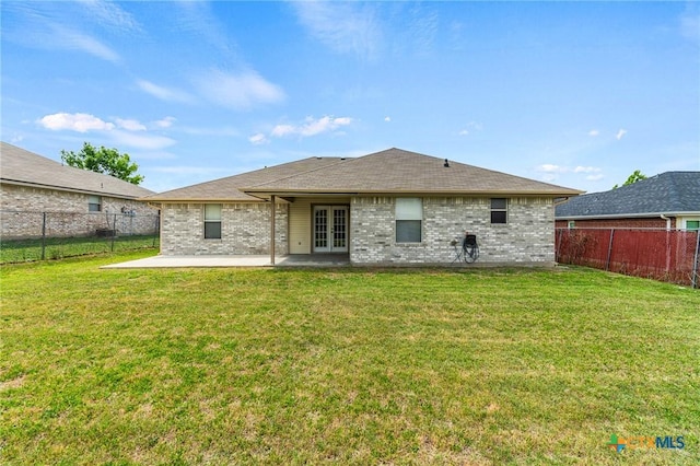 rear view of house with a patio area, a fenced backyard, french doors, and brick siding