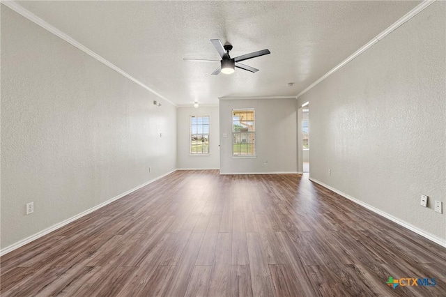 unfurnished living room with a ceiling fan, baseboards, ornamental molding, and dark wood finished floors