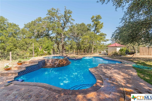 view of pool featuring a patio and an in ground hot tub