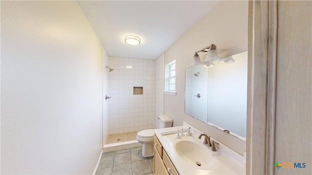 901 E Sarah St, Cuero, TX 77954 - bathroom featuring a tile shower, toilet, vanity, and tile patterned floors