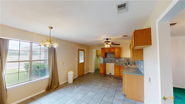 901 E Sarah St, Cuero, TX 77954 - kitchen featuring healthy amount of natural light, a sink, decorative backsplash, and a chandelier