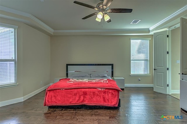 bedroom featuring wood finished floors, visible vents, and ornamental molding