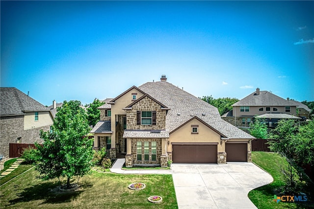 view of front of home featuring a garage and a front yard