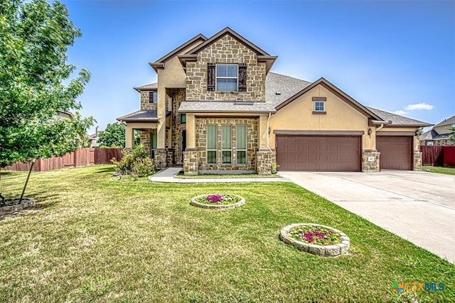 view of front of home featuring stone siding, an attached garage, concrete driveway, and fence