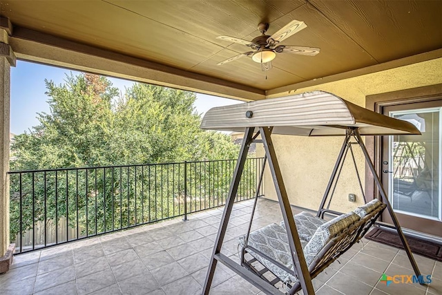 view of patio / terrace with a balcony and a ceiling fan