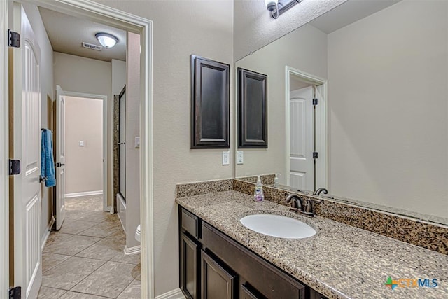 full bathroom with visible vents, baseboards, toilet, an enclosed shower, and vanity