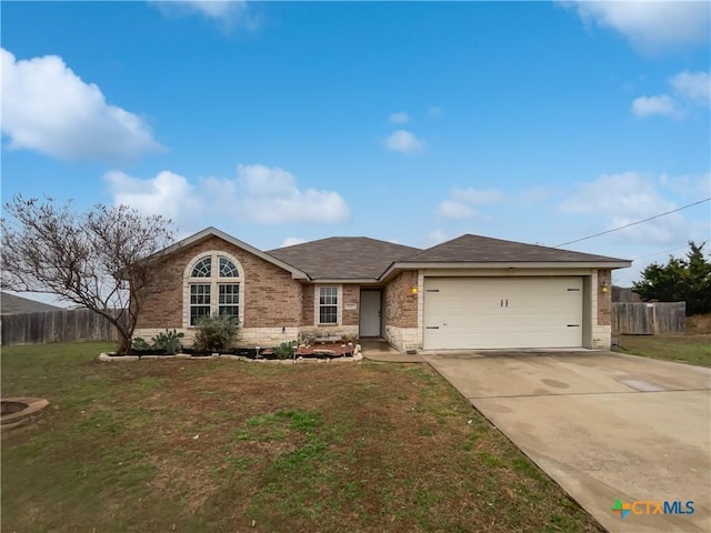 single story home with fence, a front lawn, concrete driveway, and brick siding