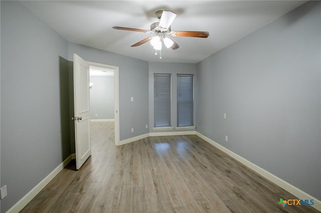 unfurnished bedroom with wood finished floors, baseboards, and ceiling fan