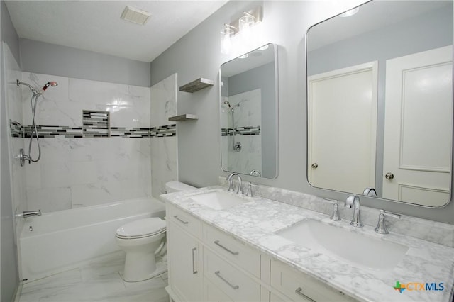 bathroom featuring marble finish floor, toilet, bathing tub / shower combination, and a sink