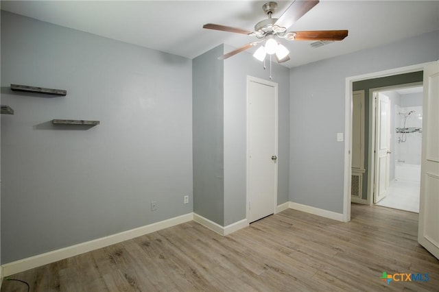 unfurnished bedroom featuring ceiling fan, baseboards, and wood finished floors