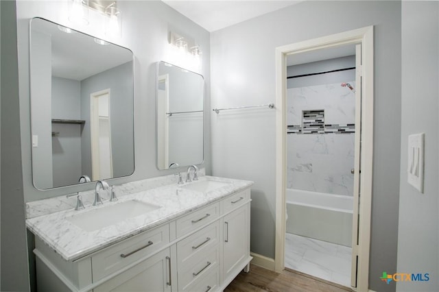 bathroom featuring a sink, shower / tub combination, marble finish floor, and double vanity