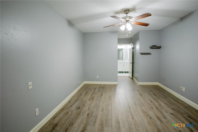 unfurnished room with wood finished floors, baseboards, and ceiling fan