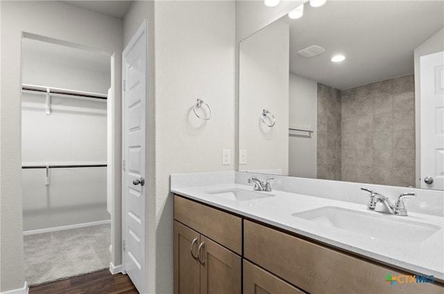 128 Bluestem Dr, Elgin, TX 78621 - full bath with wood finished floors, double vanity, and a walk in closet