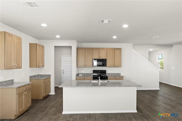128 Bluestem Dr, Elgin, TX 78621 - kitchen with black appliances, light stone countertops, an island with sink, baseboards, and recessed lighting