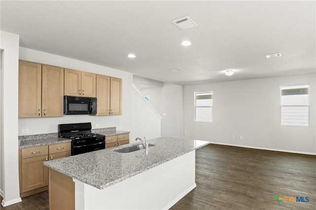 128 Bluestem Dr, Elgin, TX 78621 - kitchen featuring black appliances, a sink, dark wood-style flooring, light stone counters, and baseboards