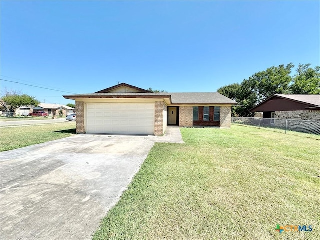 view of front facade with concrete driveway, an attached garage, fence, a front yard, and brick siding