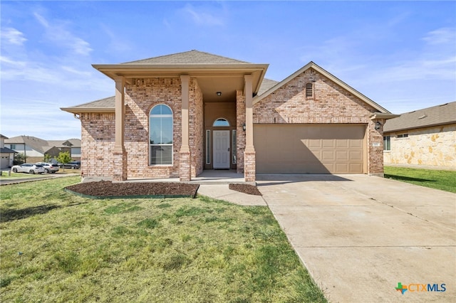 view of front facade featuring brick siding, an attached garage, concrete driveway, and a front yard